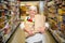 Portrait of smiling senior woman with grocery bags