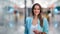 Portrait of smiling shopaholic woman posing at modern shopping mall. Medium shot on RED camera