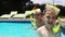 Portrait of smiling siblings in swimming pool