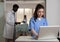 Portrait of smiling specialist physician nurse standing at desk in hospital ward