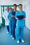 Portrait of smiling surgeons and doctors standing in corridor