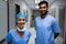 Portrait of smiling surgeons standing in corridor