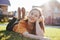 Portrait of smiling teen girl lying on sunny green grass of cottage village on background