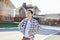 Portrait of smiling tween boy on sunny street of cottage village on background