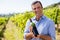 Portrait of smiling vintner examining wine