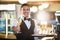 Portrait of smiling waiter offering a glass of champagne