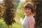 Portrait of a smiling woman 40 years walking in park at sunset