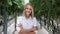 Portrait smiling woman biology scientist agronomist between cucumber plant rows at greenhouse