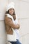 Portrait of smiling woman with bonnet on wall background.