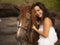 Portrait of smiling woman and brown horse. Asian woman hugging horse. Romantic concept. Love to animals. Nature concept. Bali