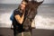 Portrait of smiling woman and brown horse. Young Caucasian woman hugging horse. Romantic concept. Love to animals. Nature concept