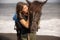 Portrait of smiling woman and brown horse. Young Caucasian woman hugging horse. Romantic concept. Love to animals. Nature concept