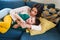 Portrait of smiling woman and child lying on sofa. Cute family is happy and looking perfect