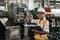 Portrait of smiling woman engineer industry worker wearing hardhat and holding cardboard looking camera.