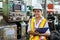 Portrait of smiling woman engineer industry worker wearing hardhat and holding cardboard looking camera.