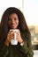 Portrait of smiling woman holding cup with drink