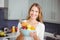 Portrait of smiling woman holding fruit bowl