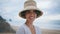 Portrait smiling woman looking camera on beach. Attractive travel girl at ocean