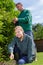 Portrait smiling woman and man professional gardening team