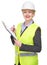 Portrait of a smiling woman in safety vest and hardhat writing on clipboard