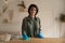 Portrait of smiling woman wipe dust from furniture