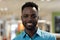 Portrait of smiling young african american businessman with stubble working at office