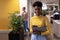 Portrait of smiling young african american female advisor holding file standing at modern workplace