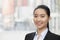 Portrait of smiling young businesswoman, head and shoulders