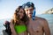 Portrait of smiling young couple with scuba mask at beach