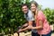 Portrait of smiling young couple using pruning shears