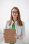 Portrait of a smiling young female doctor with medical gown and clipboard. Good healthcare concept