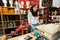 Portrait of smiling young female salesperson at checkout stand in gift store