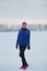 Portrait of a smiling young female sportswoman in winter ice field