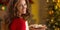 Portrait of smiling young housewife with plate of christmas cook