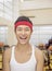 Portrait smiling young man at the gym with red headband