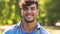 Portrait of smiling young man in summer park