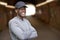 Portrait Of Smiling Young Man Wearing Baseball Cap Standing In Tunnel In In Urban Setting