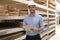 Portrait of a smiling young warehouse worker working in a cash and carry wholesale store