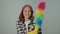 A Portrait of a Smiling Young Woman Dancing With a Dustpan.