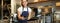 Portrait of smiling young woman providing customer service in cafe, holding cup of coffee, giving order to client