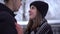 Portrait smiling young woman with teeth braces and tall man looking into each other`s eyes in winter clothing. Man