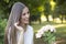 Portrait of smiling young woman who receives a gift, a bouquet o