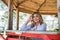 Portrait of  smiling youthful woman which enjoying vacation time, near sand beach