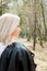 Portrait of smilling blonde young girl in the forest