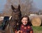 Portrait of smilling girl with her sport pony before competition