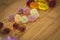 A portrait of some sugar coated sweets displayed on a wooden table.