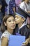 Portrait son graduated from kindergarten kissing mother