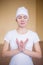 Portrait of a spiritual young woman doing yoga mudra lotos