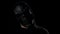 Portrait of spooky man in black skull mask looking in camera and scary you