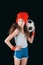 Portrait of sportive girl with soccer ball isolated on black